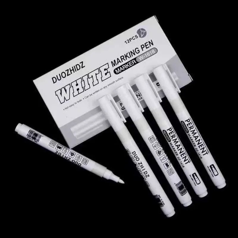 A set of white permanent markers and a packaging box for marking pens.