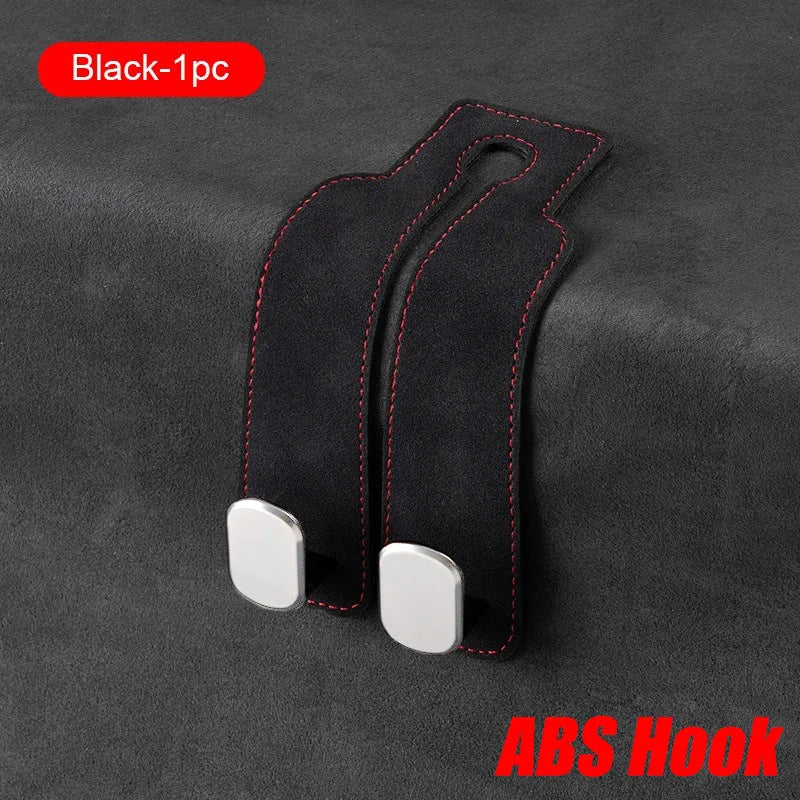 Black ABS hook for car seat back storage, featuring a suede-like strap and silver attachment.
