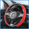 A black steering wheel with a red suede cover is visible inside a car interior.