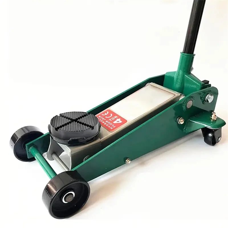A green car jack with protective pads installed on the undercarriage.