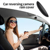 A woman is driving a car with a rain cover installed on the reversing camera.