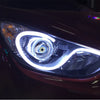 Close-up of a car headlight featuring an LED halo ring with dynamic lighting visible.