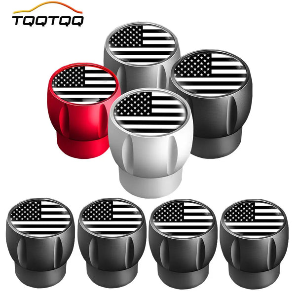 A set of four black and silver tire valve stem caps are displayed against a white background.