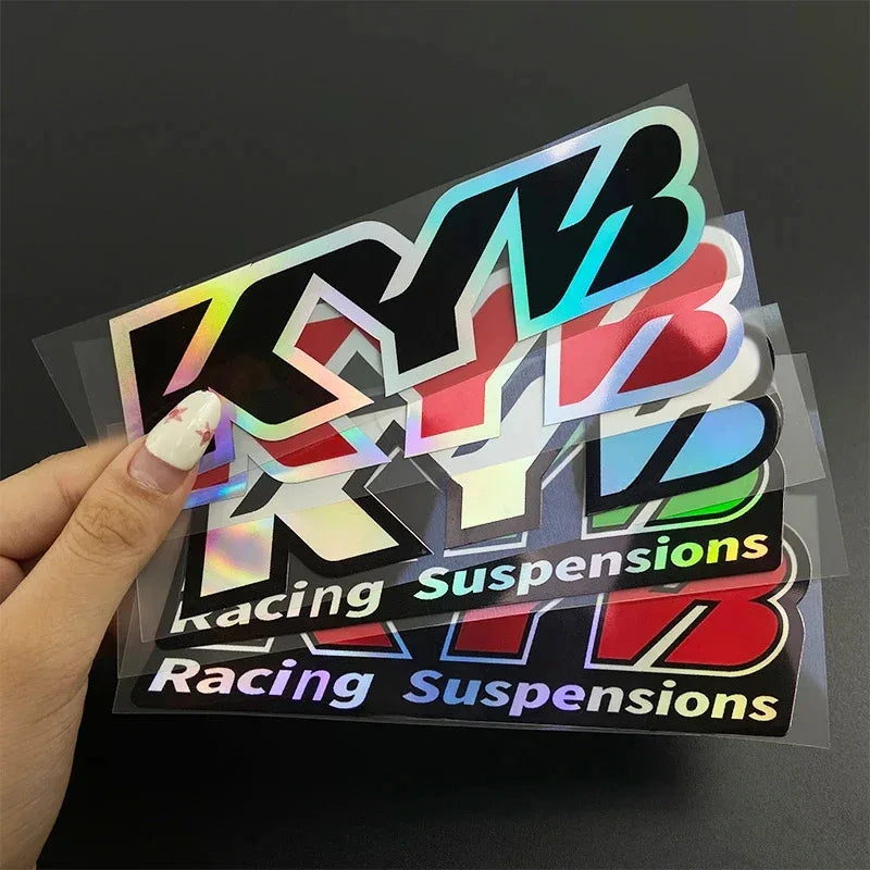 A set of iridescent and colored decals featuring the text Racing Suspensions for motorcycles.
