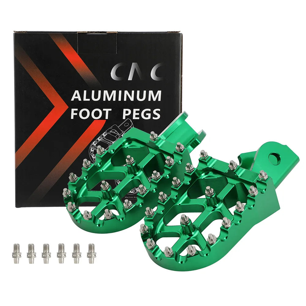 A box and several bright green aluminum foot pegs for motorcycles are shown.