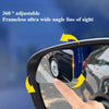 A hand adjusts a frameless ultra wide angle line of sight mirror in a car to view blind spots.