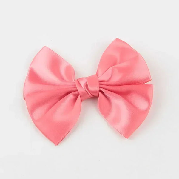 A pink silk hair bow tied in a classic bow shape.