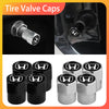 A set of four durable anodized tire valve caps in black and silver finishes.
