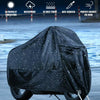 Black heavy-duty motorcycle cover protecting a bike from the elements.