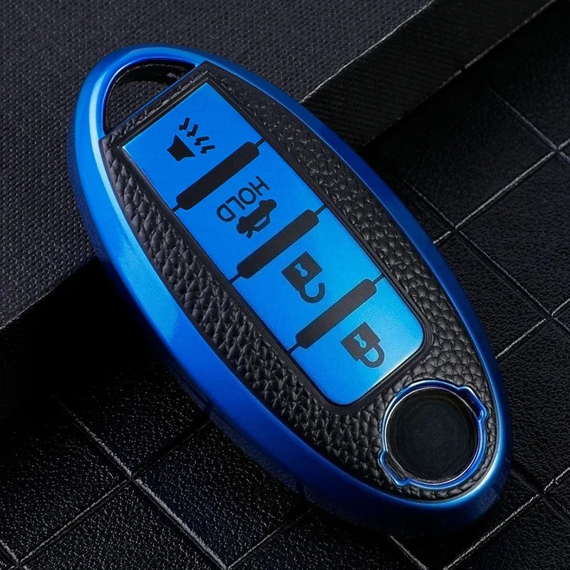 A blue car key fob cover with a black textured surface and a round button.