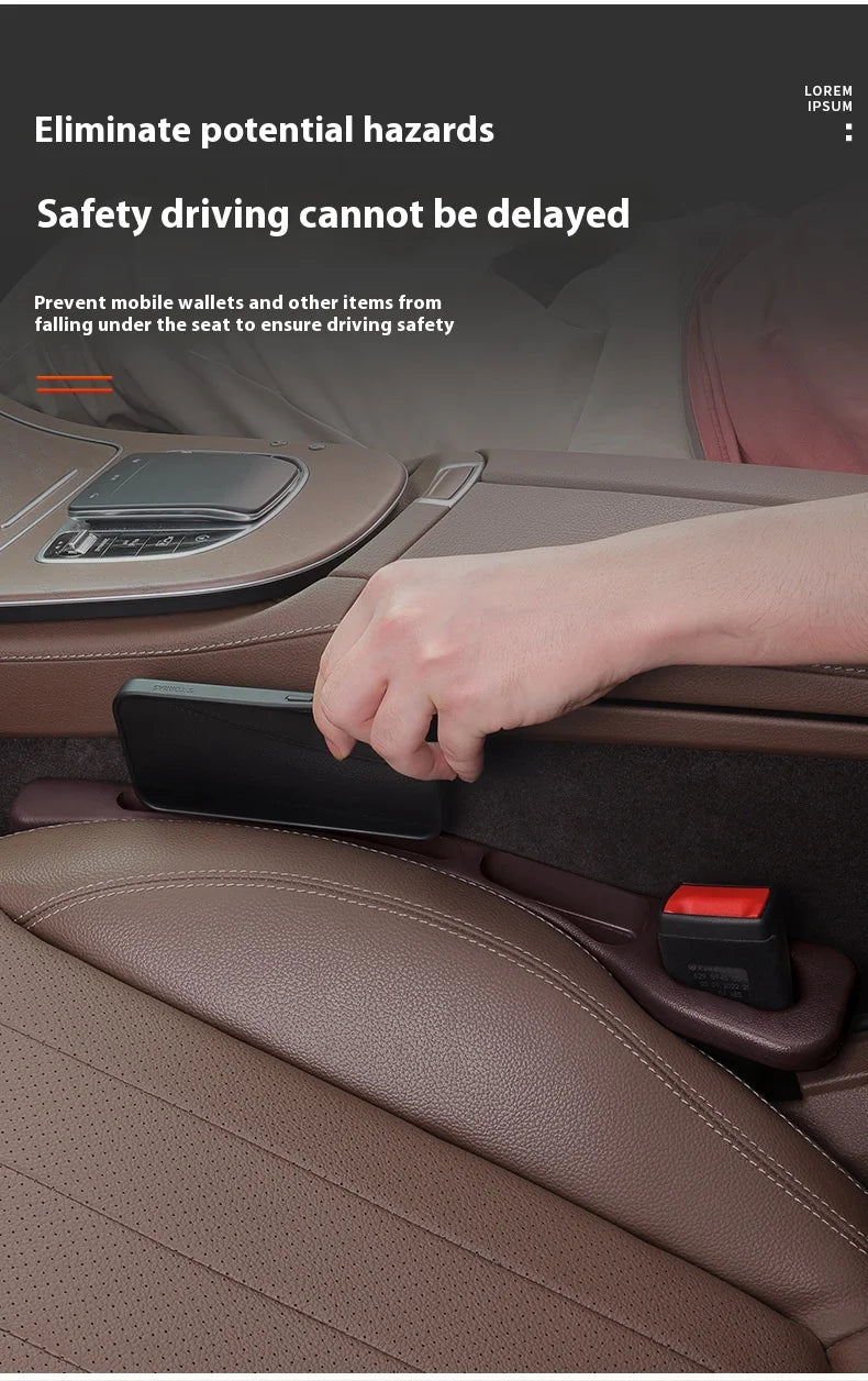 A hand places a smartphone into a storage organizer designed to prevent items from falling under a car seat.