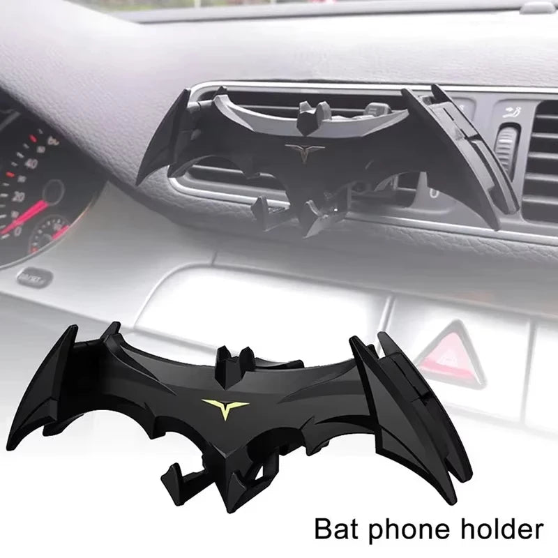 Black bat phone holder mount installed in a car dashboard slot.