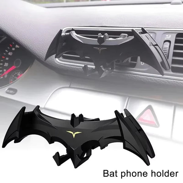Black bat phone holder mount installed in a car dashboard slot.