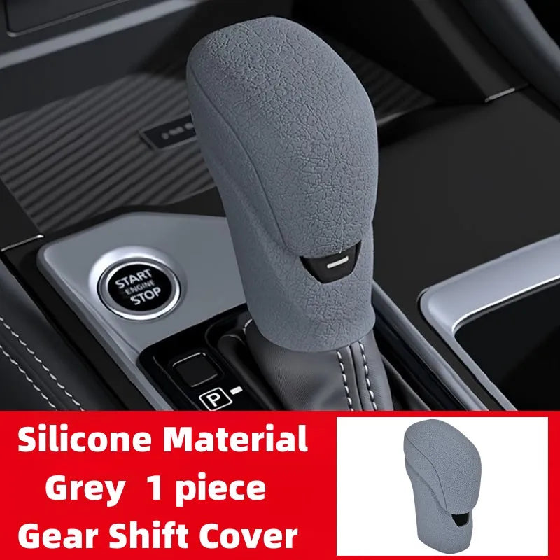 A grey silicone gear shift cover is shown in a vehicle interior setting.