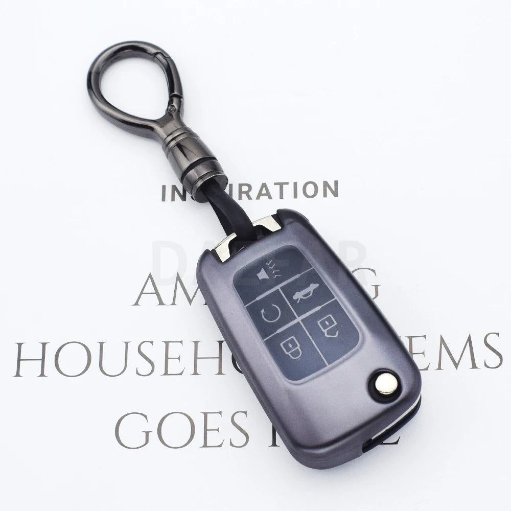 A black universal car key cover with a metal hook is shown against a white background.