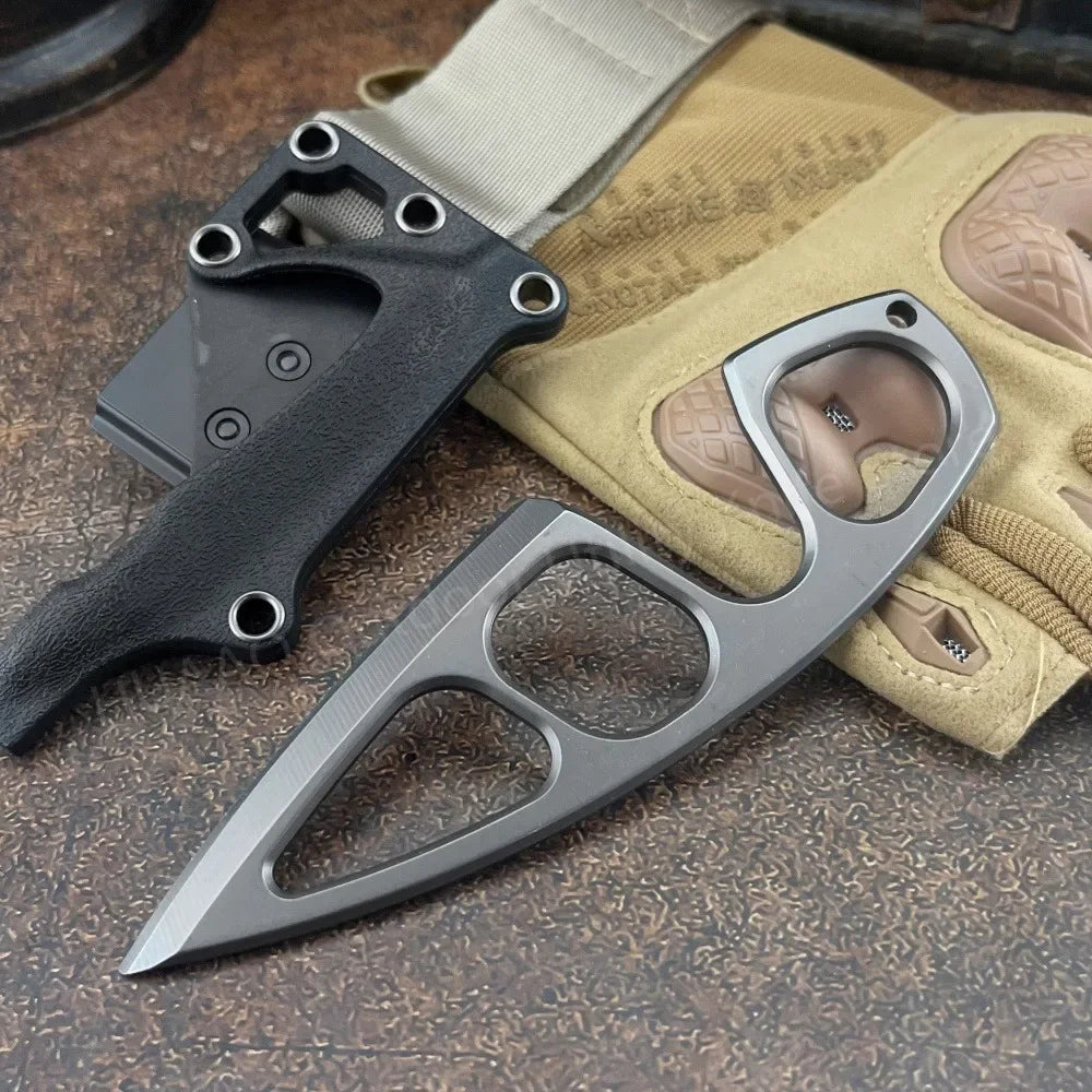 A durable stainless steel fixed blade survival knife is shown next to a tan fabric and a black sheath.