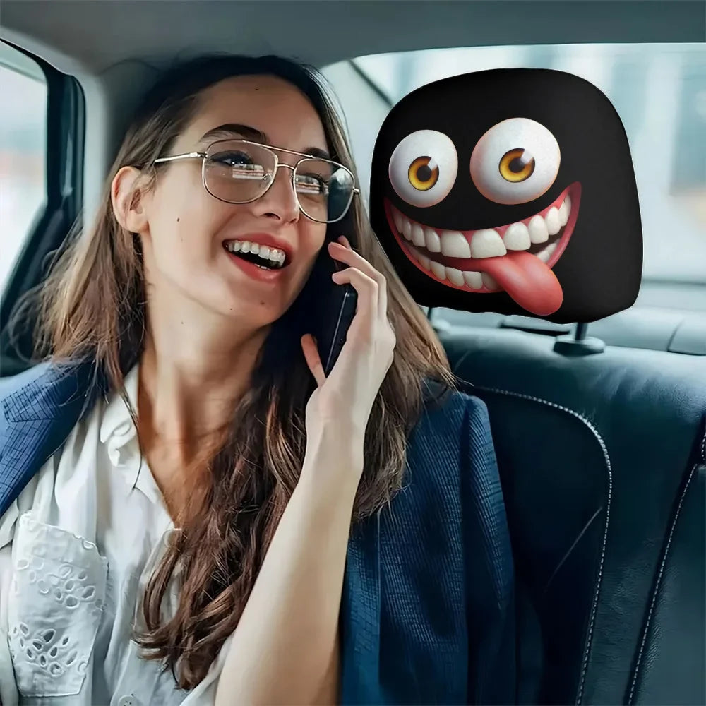A woman is holding a phone while sitting in a car, with a funny cartoon face headrest cover visible on the passenger seat.