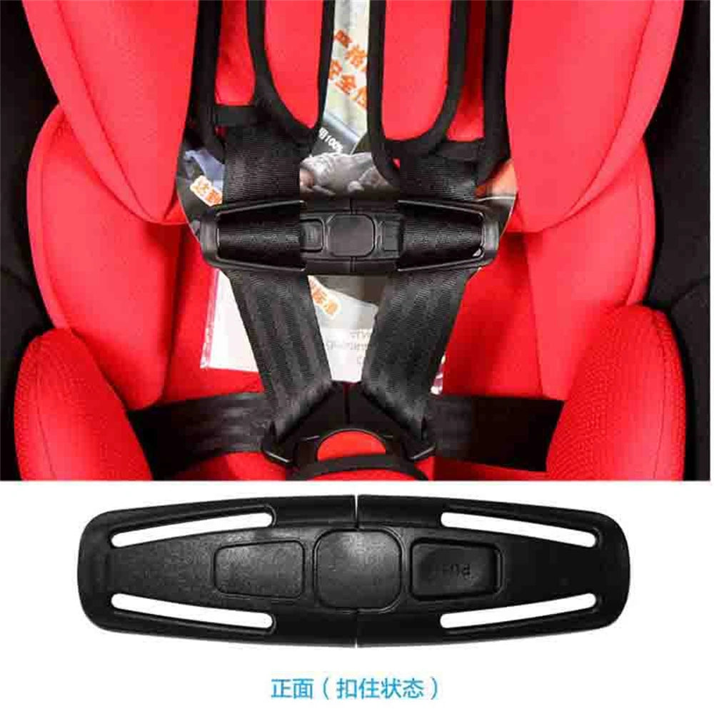 A black car seat belt clip is shown against a red fabric background.
