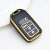 Étui pour clé de voiture en TPU universel noir et or avec plusieurs boutons sur une surface blanche.