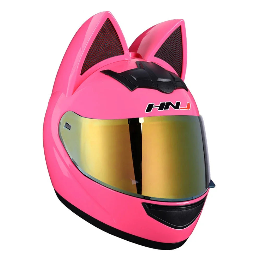 A bright pink cat-ear full face motorcycle helmet with a gold visor and black accents.