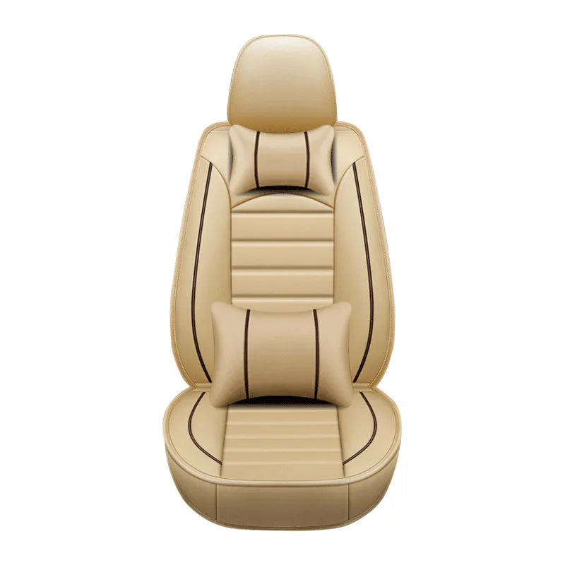 Tan leather car seat covers for a five-seater vehicle, featuring stitching and decorative pillows.
