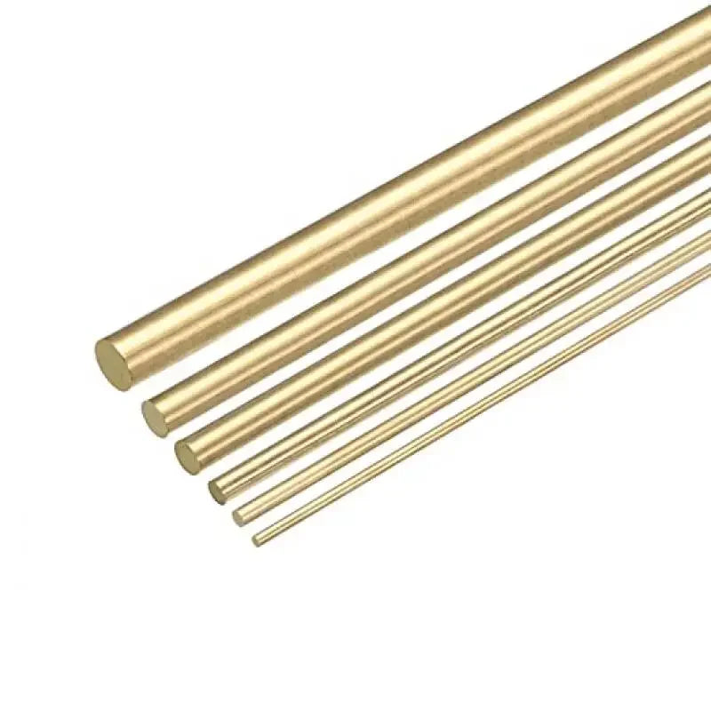A collection of parallel brass bar rods shown at an angle against a white background.