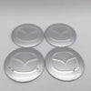 Four silver center caps or decals for 3D car wheel hubs.