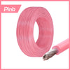 Pink insulated multi-stranded copper wire coiled and a section unwound