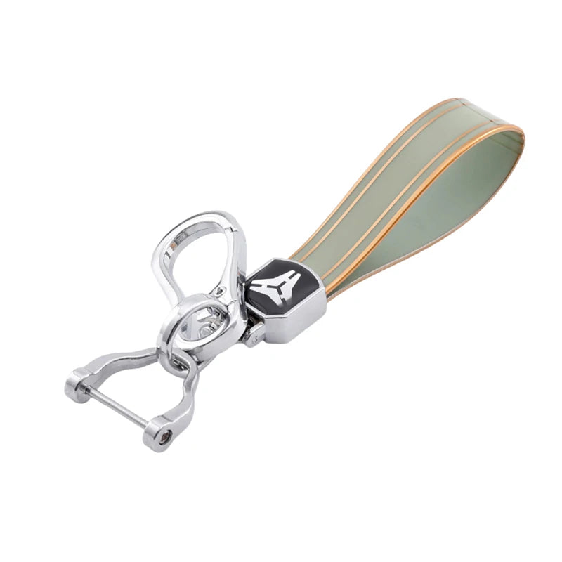 Silver key fob case with a translucent green silicone cover and a metal clip.