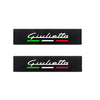 Two black shoulder cushions with the name Giulietta printed in white and colored stripes of green and red