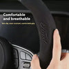 Close-up of a black steering wheel cover for a Ford vehicle showing a hand gripping the breathable, non-slip grip.