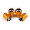 Three gold metal tire valve caps with black VW logos displayed on a white background.