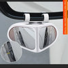 A white 360° adjustable car blind spot mirror is mounted on a vehicle window frame.