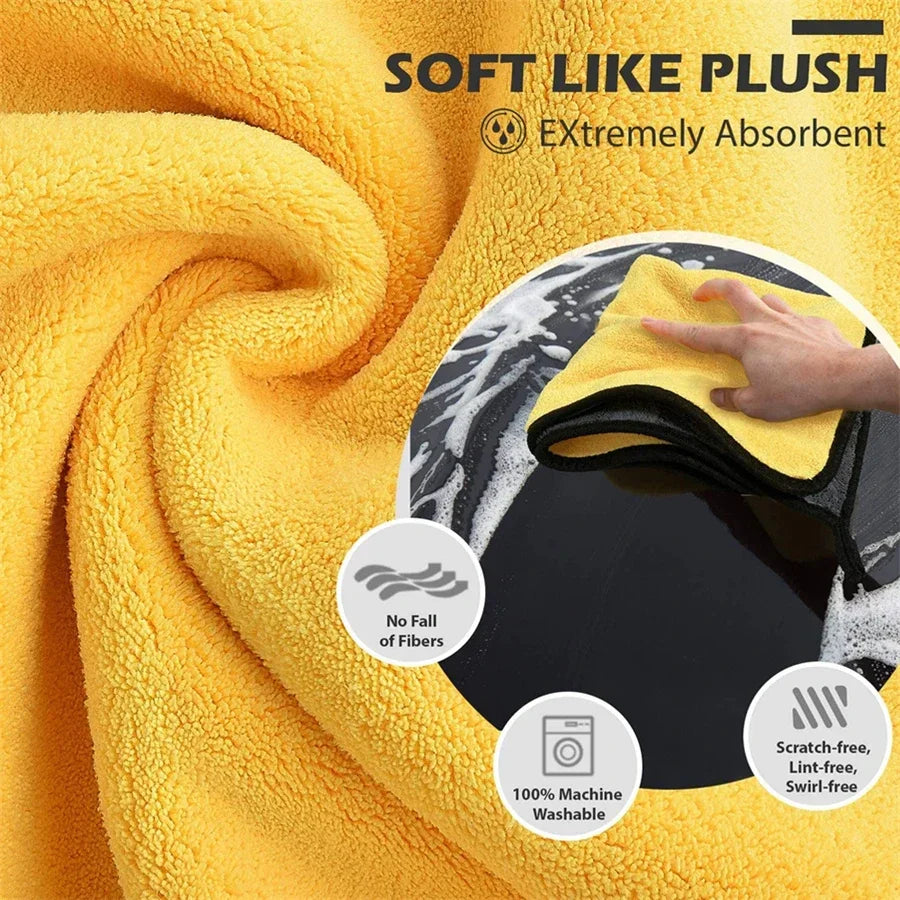 Yellow plush microfiber car cleaning towels being squeezed onto a dark surface.