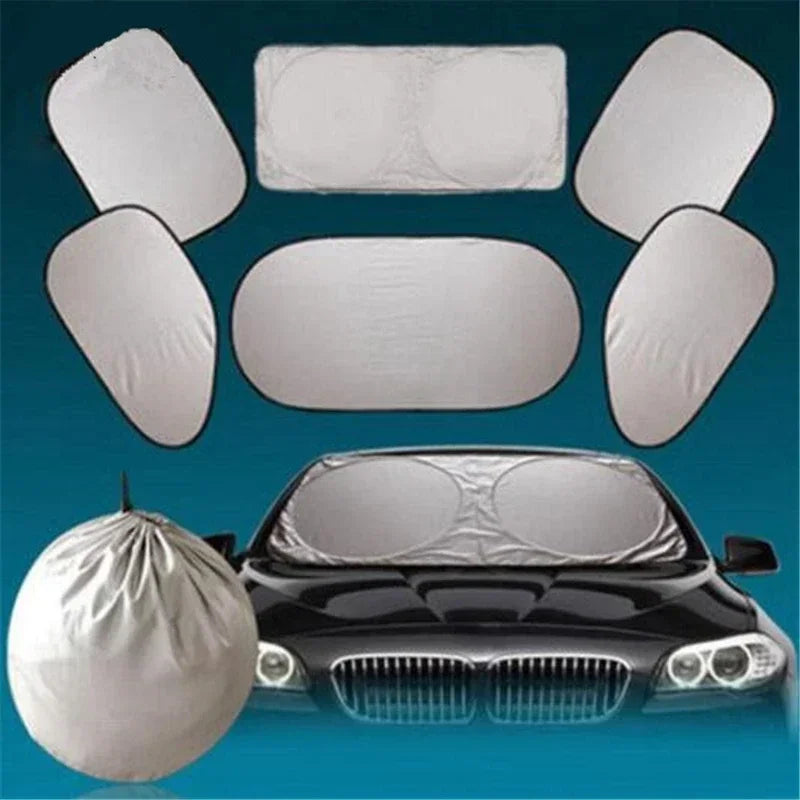 A set of six white car windshield sun shades displayed above a black car.