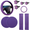 A set of purple car interior accessories including a steering wheel cover, comfort pads, and leather-like grips.