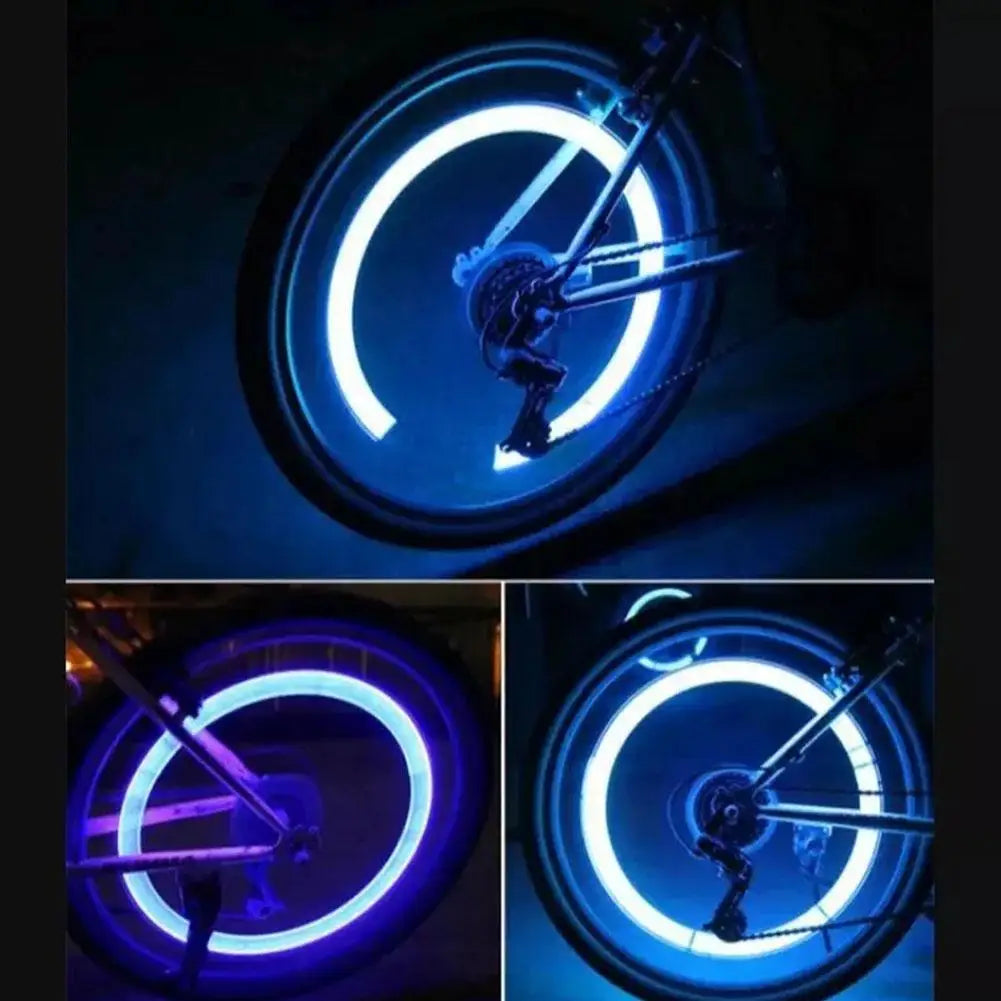 Close-up of a bicycle wheel illuminated by bright blue LED lights.