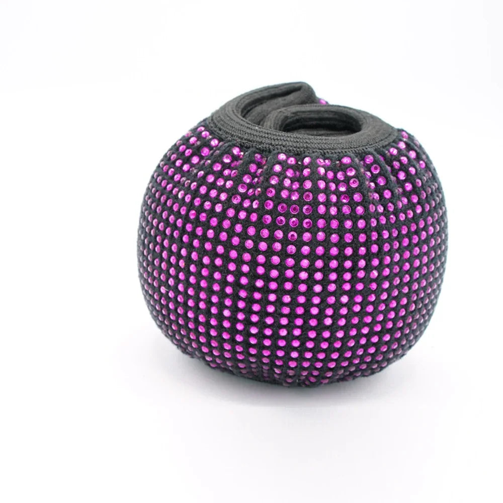 A round steering wheel cover made of black fabric studded with bright pink crystal diamond rhinestones.