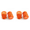 Three orange aluminum Ford car wheel valve caps shown side by side.