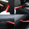 Close-up images showing a red vinyl wrap tool being used to remove a black car vinyl wrap from a car interior.