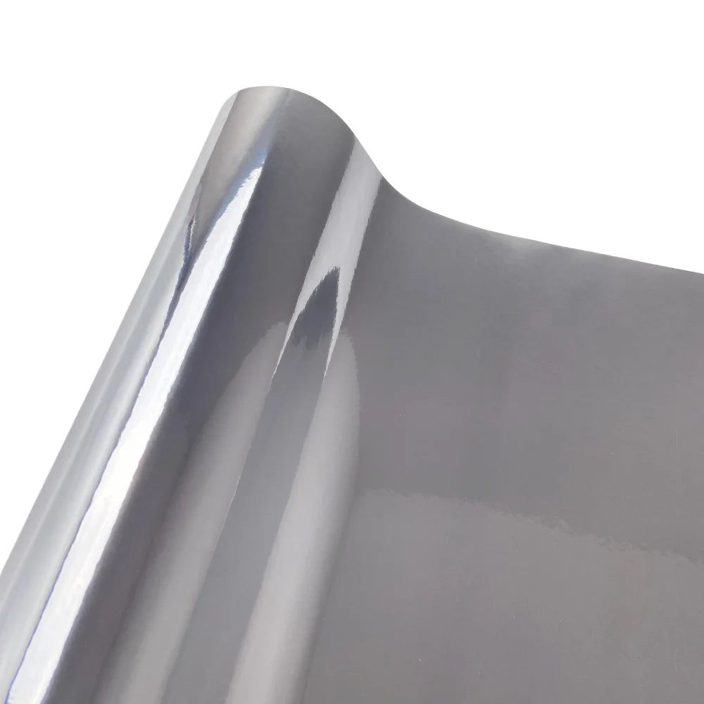 Close-up view of a smooth, curved section of multi-color gloss chrome vinyl car wrap film.