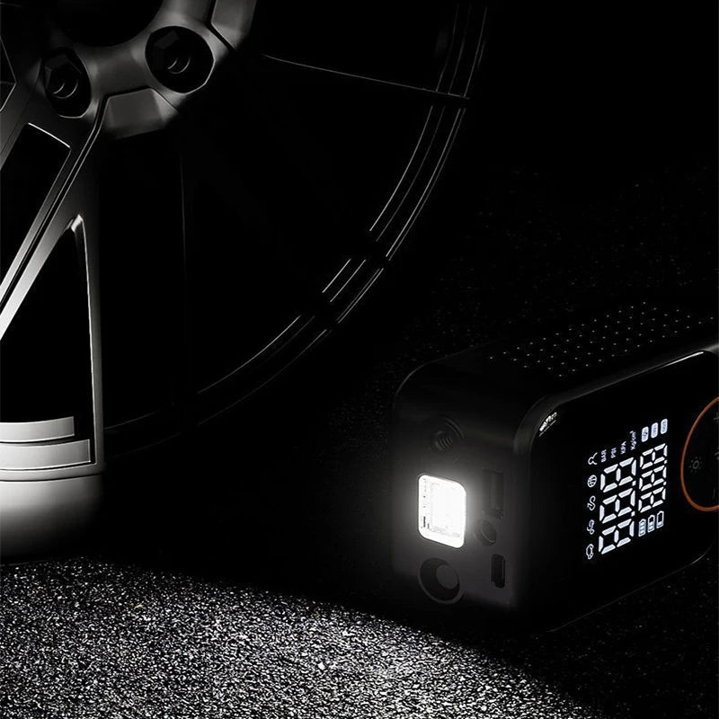 A black wireless portable tire inflator with a digital display is shown on a textured surface.