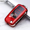 A red TPU car key cover is shown, featuring a digital display and key slot, resting on a white marble surface.