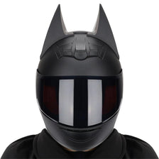 A black full face motorcycle helmet with detachable horns shown from the front.