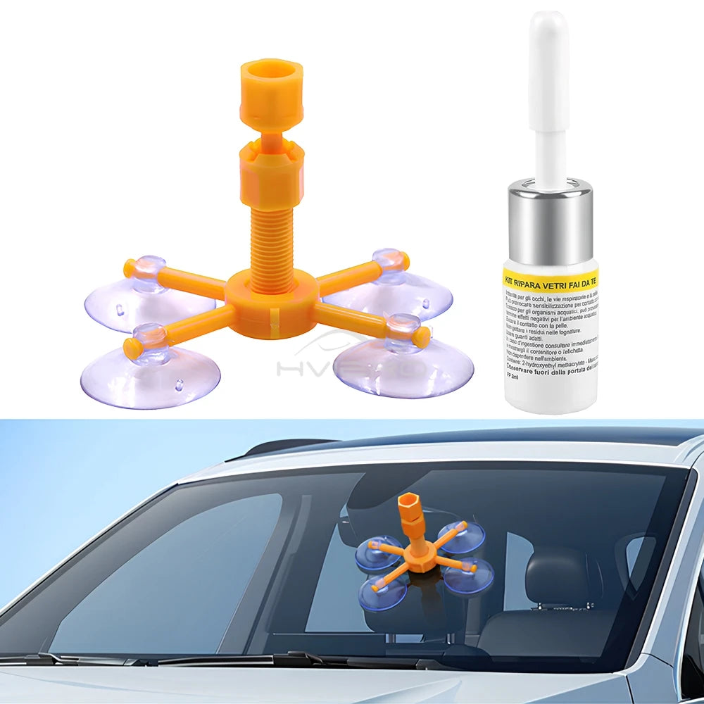 Kit profesional de reparación de parabrisas naranja con múltiples ventosas junto a una botella.