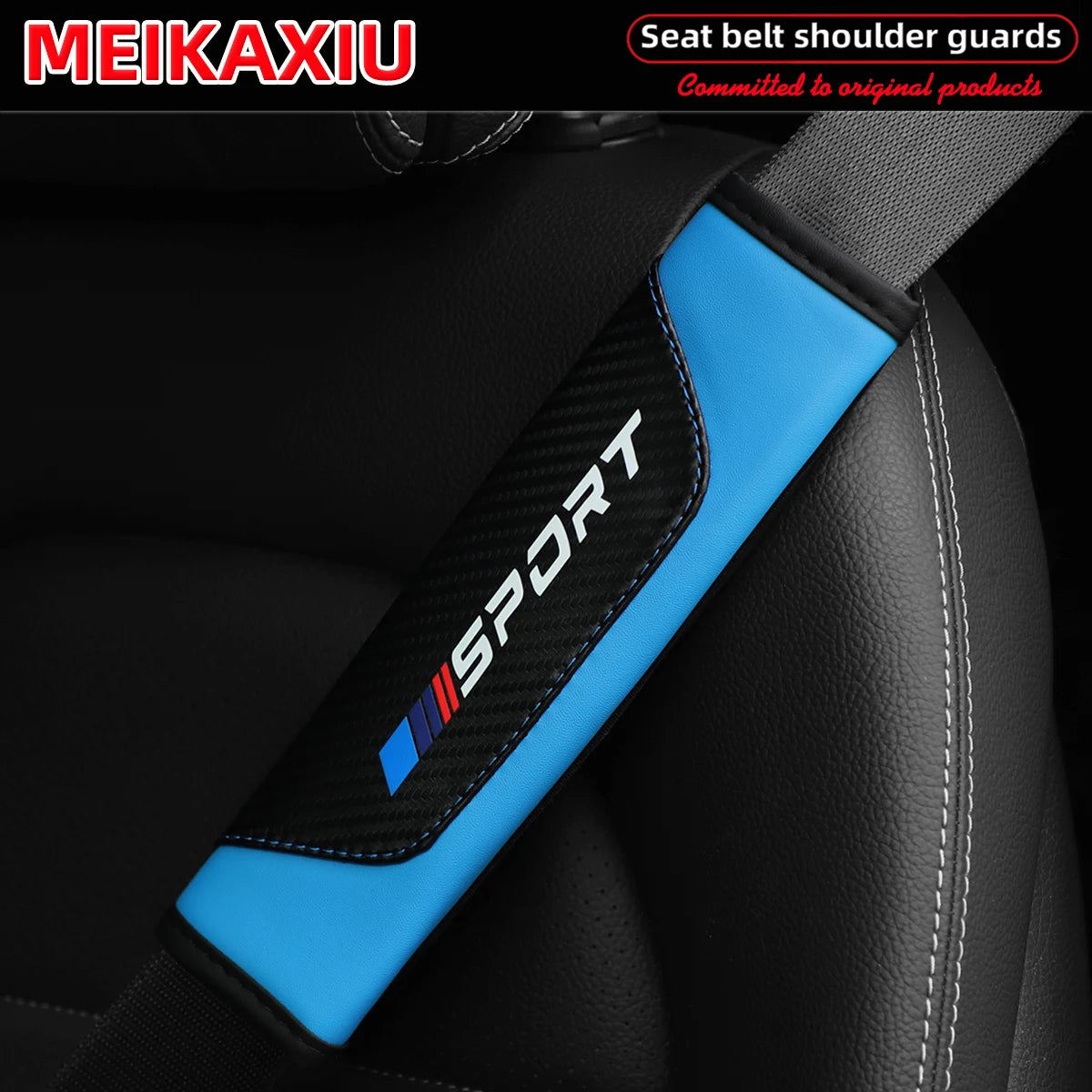 Blue and black PU leather carbon fiber seat belt shoulder guard installed on a black car seat.