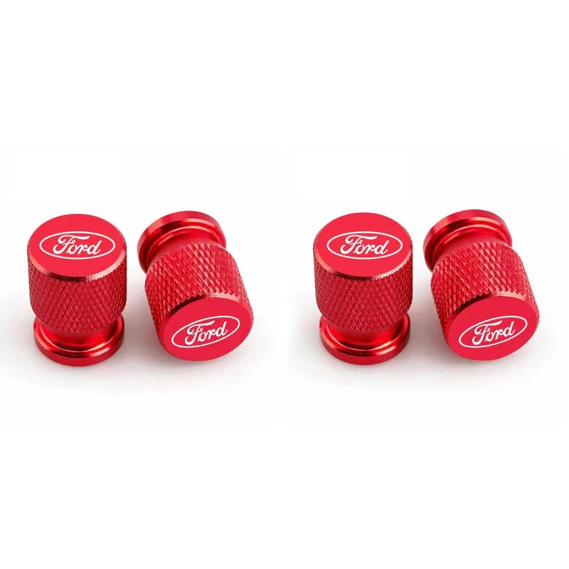 Three red Ford aluminum car wheel valve caps displayed side by side.