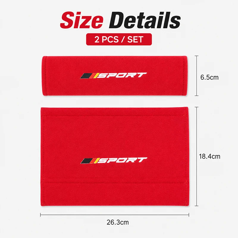 A set of two red sports shoulder pads for car seat belts, showing their size and dimensions.
