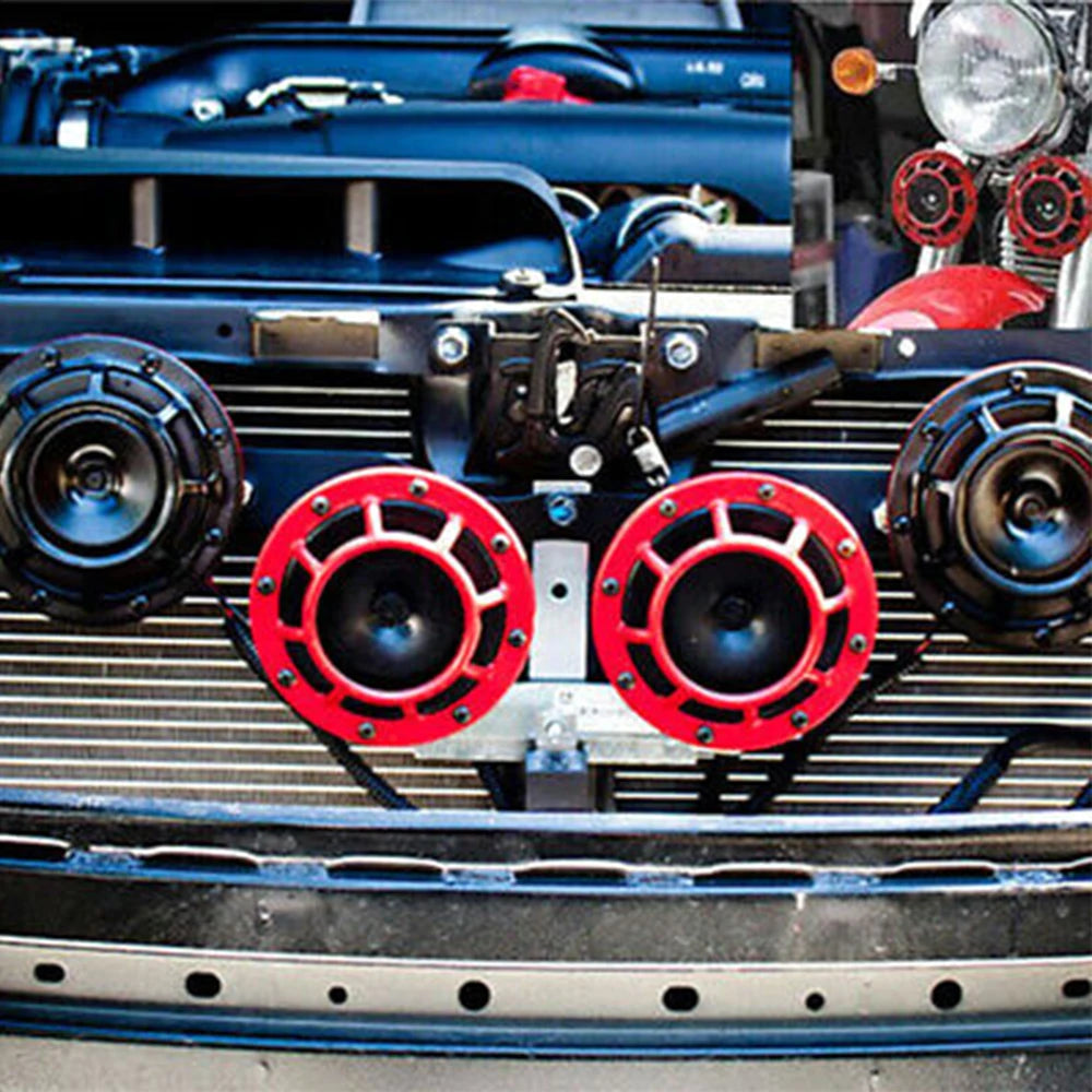 Close-up of a dual tone electric air horn kit installed on a vehicle grille.