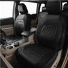 Interior view of a car seat with black leather covers installed on the seats and dashboard.